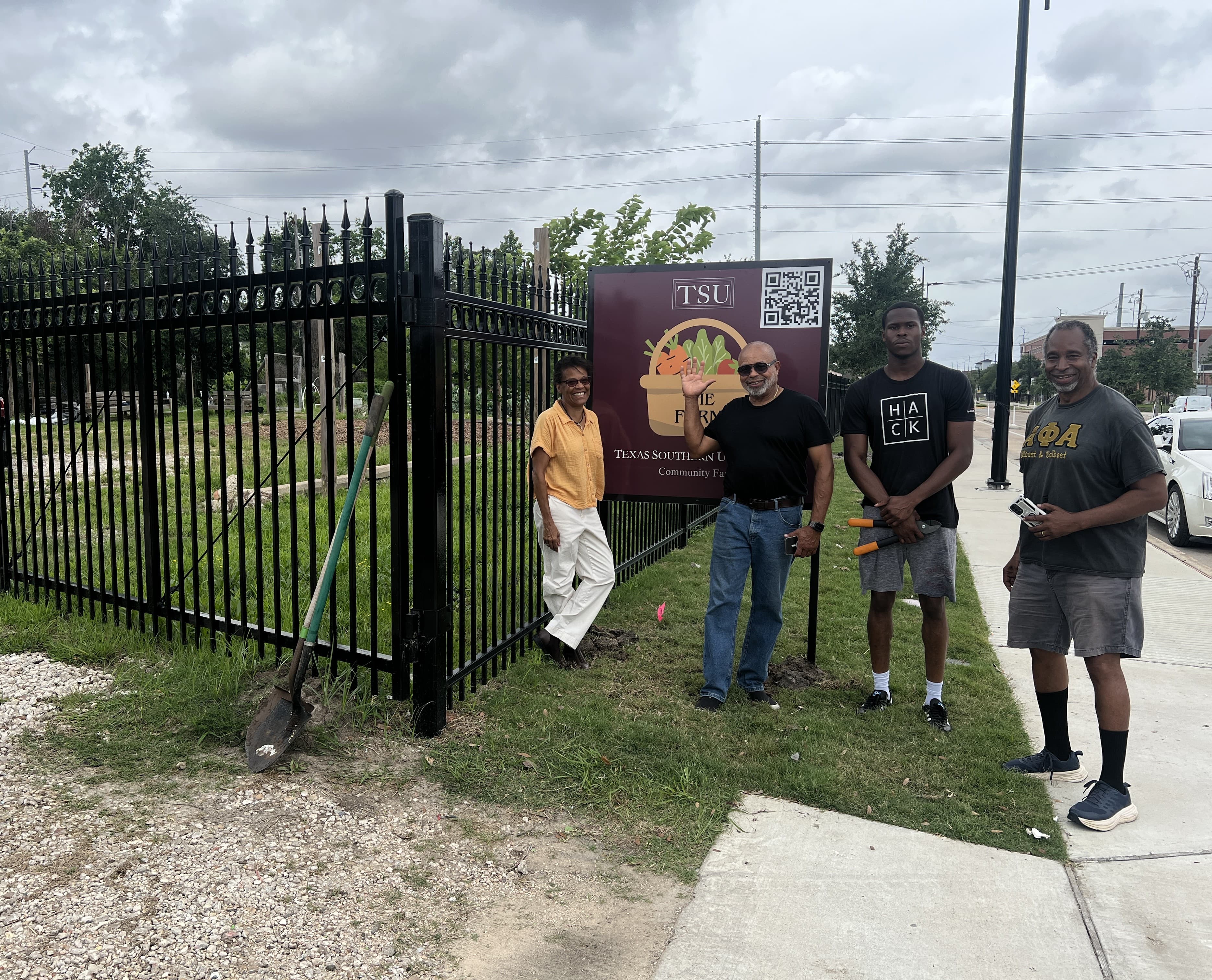 Farm team by the entrance sign